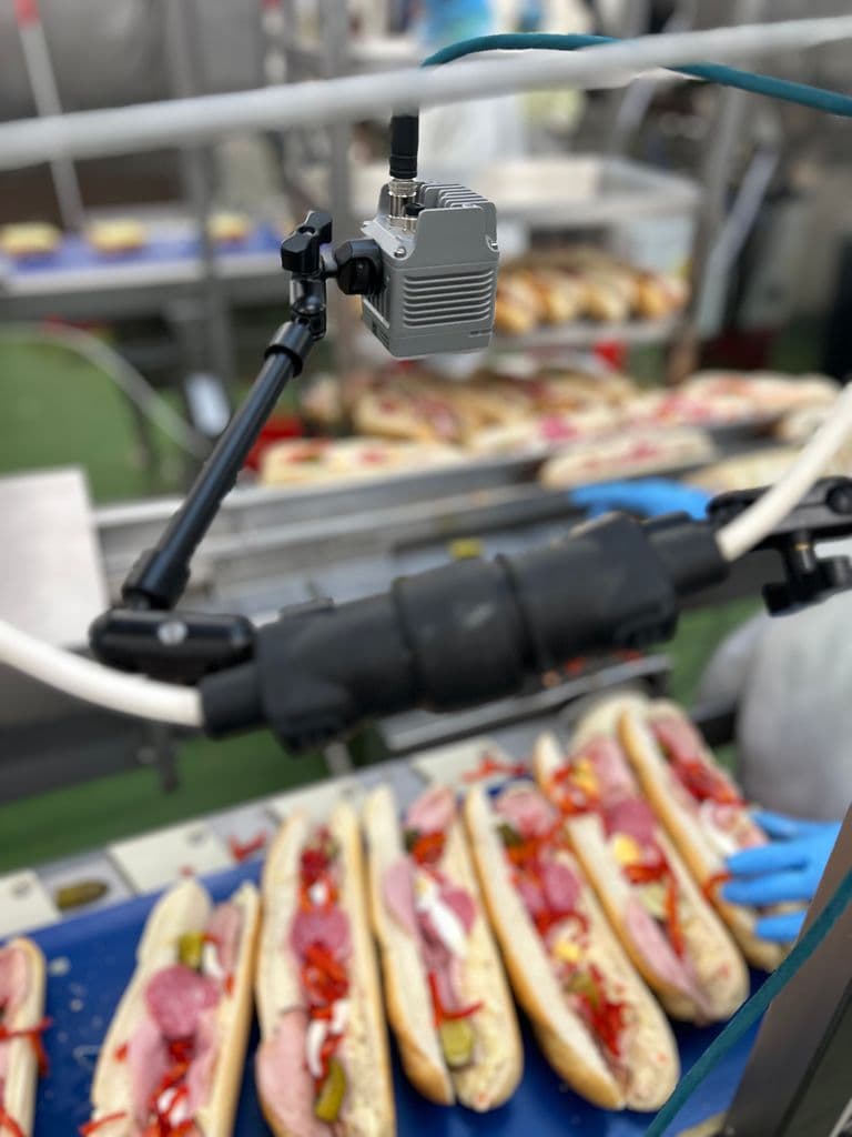 Sealed camera mounted above a production line
